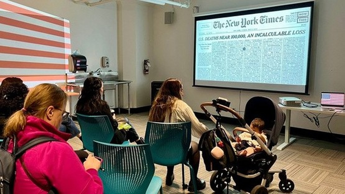 Guests seated in a room with the American flag and a New York Times front page projected, hearing the other account of the pandemic.